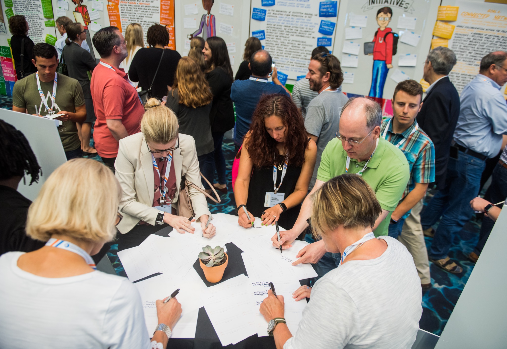 A diverse group working together around a Summit table